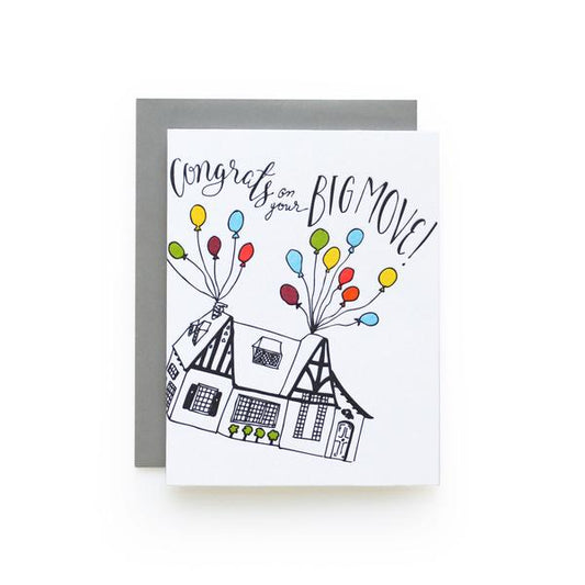 White greeting card with a sketch of a house being lifted off the ground by colorful balloons and the text "Congrats on Your Big Move!"